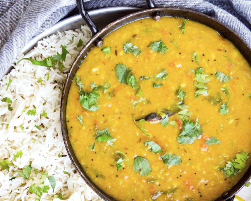 dal in a pot on a bed of white rice